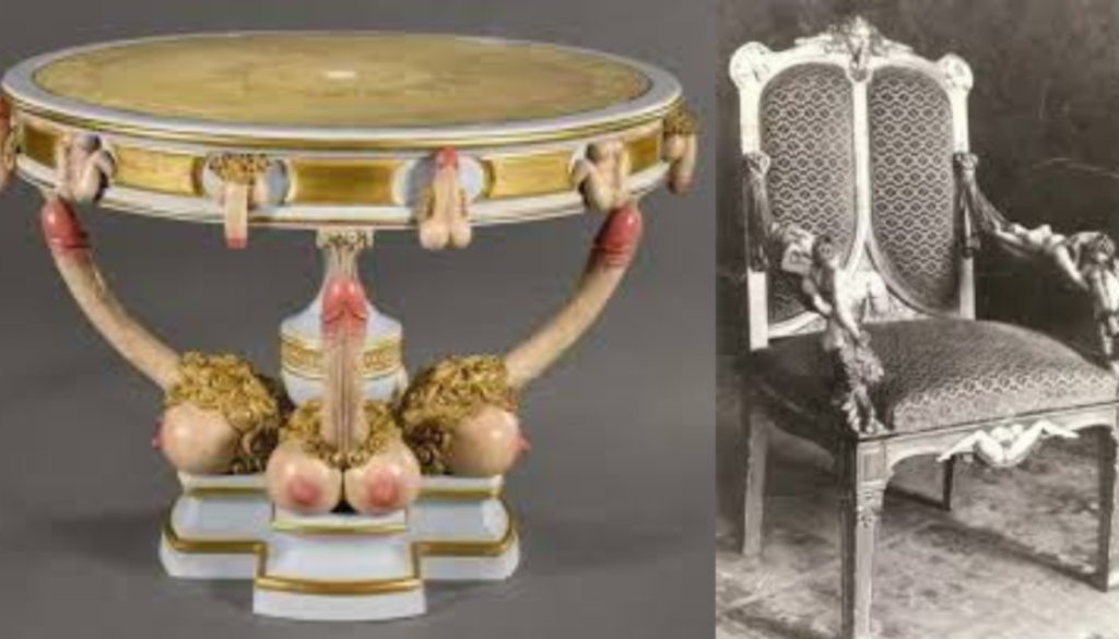 An ornate circular table with a marble top, supported by three elephant heads with tusks and trunks forming the base, paired with an intricately carved chair with a high backrest and cushioned seat.