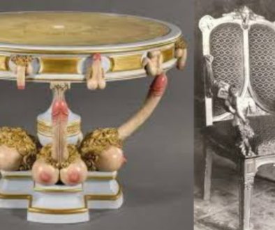 An ornate circular table with a marble top, supported by three elephant heads with tusks and trunks forming the base, paired with an intricately carved chair with a high backrest and cushioned seat.