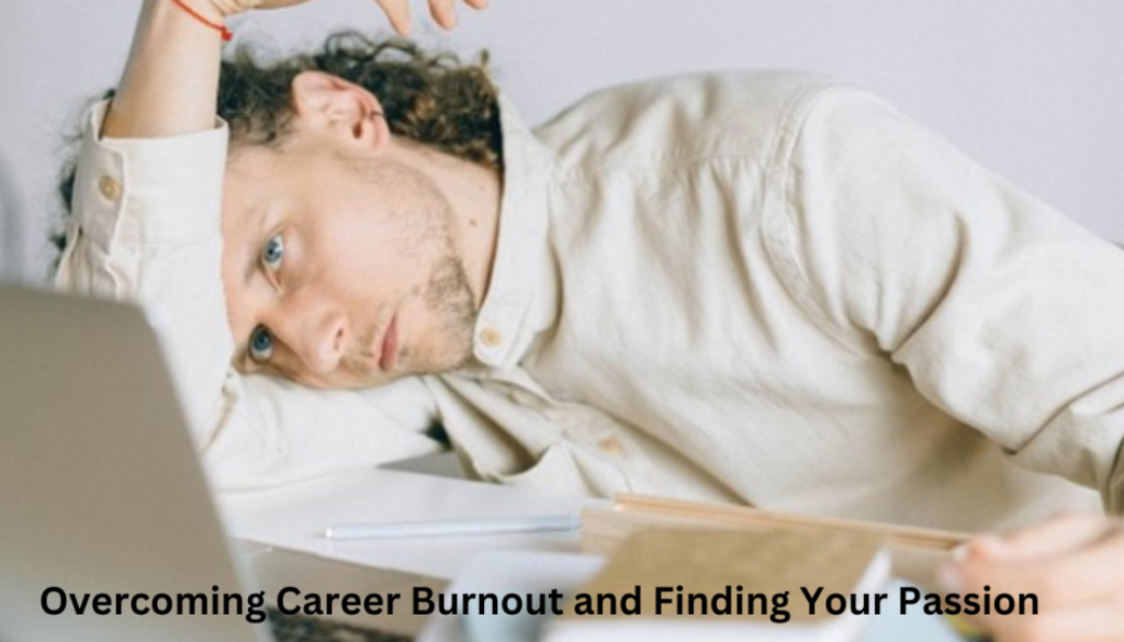 An individual leaning on a desk with their head resting on their arm, appearing exhausted, with a blurred laptop and papers in the foreground. A title overlay reads “Overcoming Career Burnout and Finding Your Passion.